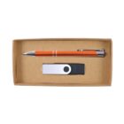 A brown cardboard box containing an orange pen with silver accents and a black and white USB flash drive. The items are neatly arranged side by side in the box.