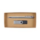 A cardboard box containing a silver pen and a USB flash drive. The pen is placed horizontally at the top, and the USB flash drive, with a swivel cap, is positioned below it.