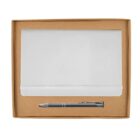 A white notebook with an elastic band is placed beside a silver pen inside a brown cardboard box.