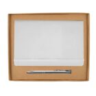 A white notebook with an elastic band is placed inside an open brown box. Below it is a silver pen. The items are neatly arranged inside the box.
