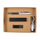 A cardboard box containing a silver and black pen, a black USB flash drive, a white USB cable, and a sleek black rectangular item.