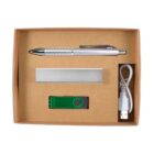A cardboard gift box containing a silver pen, a metallic rectangular case, a green and silver USB flash drive, and a white USB cable, all neatly arranged.