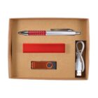 A cardboard box contains a red and silver pen, a red rectangular power bank, an orange USB drive, and a white USB charging cable.