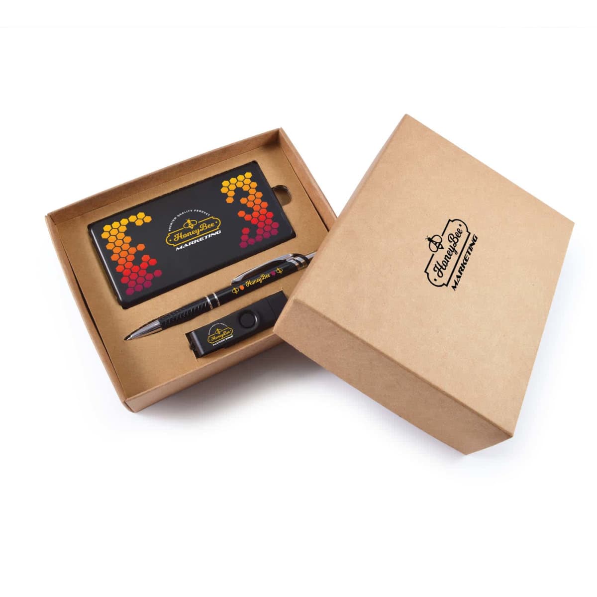 A brown gift box with branding contains a power bank with a colorful dotted pattern, a pen, and a USB drive. The box is partially open, displaying the contents neatly arranged inside.