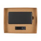 A rectangular, black portable battery pack and a USB charging cable with a button, both neatly placed in a brown cardboard box with cutouts for fitting. The background is plain white.