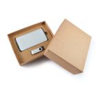 An open brown cardboard box reveals a power bank and a metallic USB flash drive inside. The lid is slightly tilted, showing the contents clearly against a white background.
