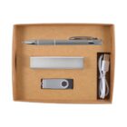 A brown cardboard box containing a silver pen, a rectangular power bank, a USB flash drive, and a white USB cable, all neatly arranged side by side.