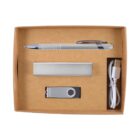 A brown box containing a pen, a rectangular power bank, a USB flash drive, and a white USB charging cable.