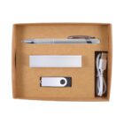 A kraft box containing a silver pen, a power bank, a USB flash drive, and a USB charging cable, all neatly arranged in separate compartments.