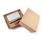 Open cardboard gift box containing a smartphone, a stylus, and a red USB drive against a plain white background. The box lid is partially off, revealing the contents inside.