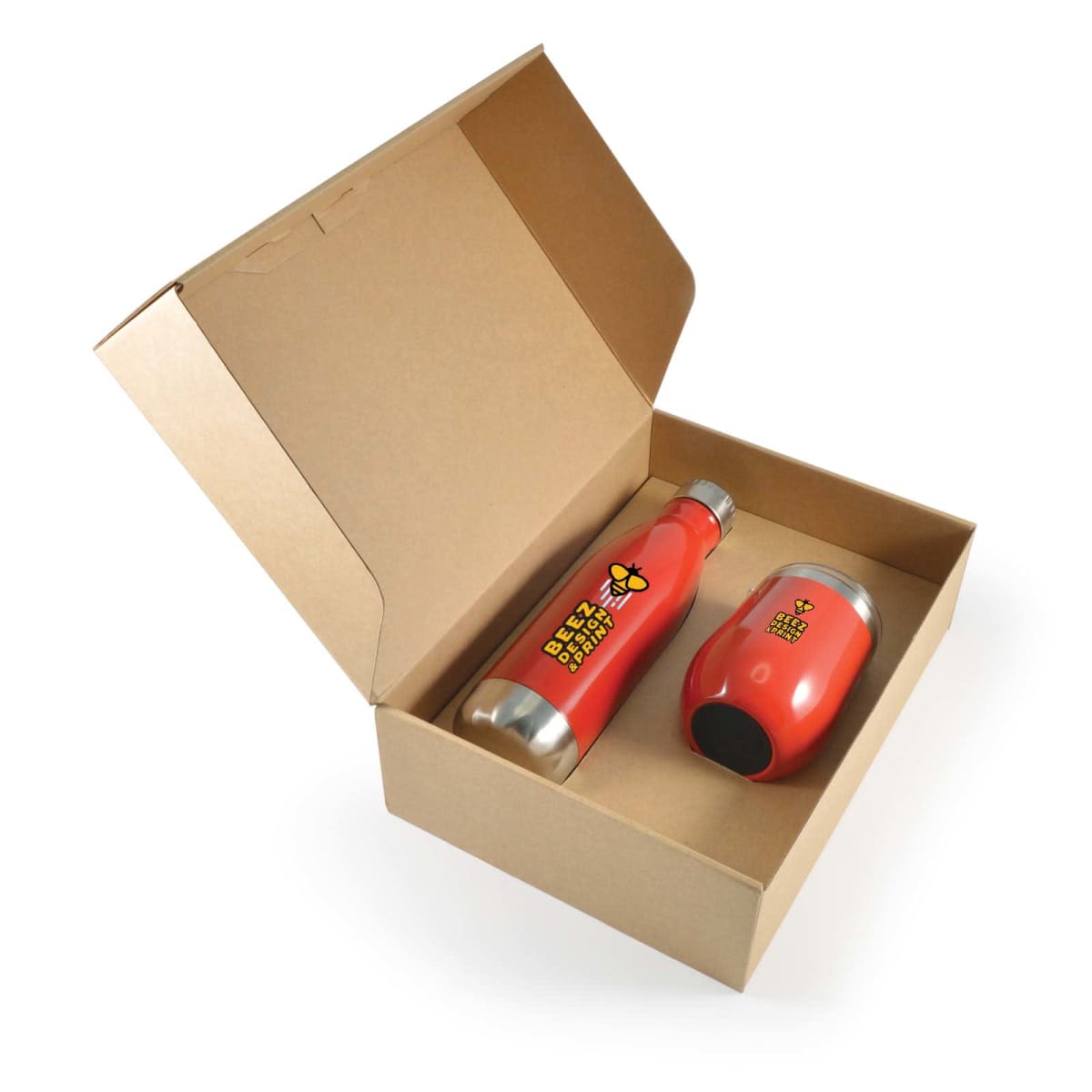 Open cardboard box containing a red insulated water bottle and a red insulated tumbler, both with a bee illustration and text BEEZ NEEZ HONEY on them. The tumbler is placed sideways next to the bottle.