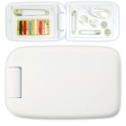 A compact white sewing kit is open, displaying various colored threads, a needle, safety pins, buttons, and a small pair of scissors. The bottom half of the kit is closed.