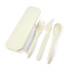 A set of off-white reusable cutlery including a fork, knife, and spoon is displayed next to a matching rectangular case with a lid, all on a plain white background.