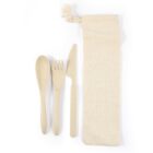 A set of beige, eco-friendly utensils including a spoon, fork, and knife, placed next to a cream-colored fabric pouch with a drawstring closure. The utensils and pouch are neatly arranged on a white background.