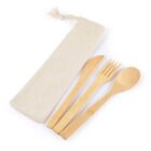 A set of bamboo cutlery including a knife, fork, and spoon is placed next to a beige fabric pouch with a drawstring. The items are laid out on a plain white background.