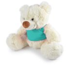 A fluffy white teddy bear with a light brown nose is sitting and wearing a teal shirt. The bear looks soft and cuddly, with large paws and a gentle smile.