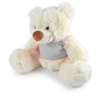 A fluffy white teddy bear with a brown nose and a soft gray bib sits upright. Its ears and paws are round and plush, adding to its cuddly appearance.