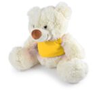 A fluffy white teddy bear wearing a yellow bib sits against a plain white background. Its feet are spread out, and it has a brown nose with a friendly expression.