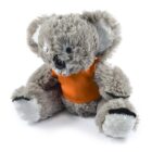 A fluffy gray koala stuffed toy wearing an orange shirt. Its large ears, round black nose, and white facial accents create a friendly appearance. The toy is seated against a plain white background.