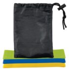 A black drawstring bag is placed above three folded resistance bands in green, blue, and yellow. The bands are stacked neatly on a white background.