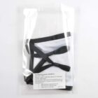 A reusable face mask in black and white is packaged in a clear plastic bag. The mask features black elastic ear loops and a visible label with care and fitting instructions in black text.