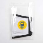 A face mask in a clear plastic bag. The mask is white with black edges and has a yellow circular logo featuring a train icon and the word metro in blue.