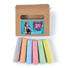 A box labeled EDUKATE with a website and phone number. In front, there are six sticks of colored sidewalk chalk in shades of peach, orange, blue, yellow, pink, and green.