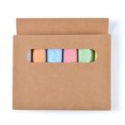 A set of five pastel-colored sidewalk chalk sticks in blue, yellow, orange, pink, and green is partially visible through an oval window in a brown cardboard box.