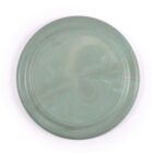 A round, green plate with a subtle marbled pattern on its surface. The plate has a smooth, glossy finish with shades of light and dark green swirling throughout. The background is plain white, highlighting the plates design.