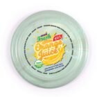 A green frisbee with a label reading Aussie Fresh 100% Orange Juice and an image of an orange slice. Text around the rim emphasizes Recycle - Reuse and mentions local availability in the supermarket juice section.
