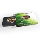 A rectangular tin with the word Dynamo on the lid is partially inside a green and white cardboard sleeve. The sleeve features the text Help When Its Needed and an address in NSW, Australia.