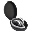 Black and white wireless headphones folded inside an open black zippered carry case. The case has a smooth outer surface and snugly fits the headphones, displaying them prominently.