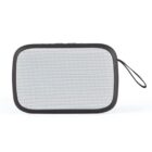 Portable speaker with a rectangular design and a black border. The front is covered with a white perforated grill. It has a small black carrying loop attached to one side.