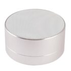 A silver, cylindrical Bluetooth speaker with a perforated top grille, designed for sound output. The speaker has a minimalist design and a smooth surface.