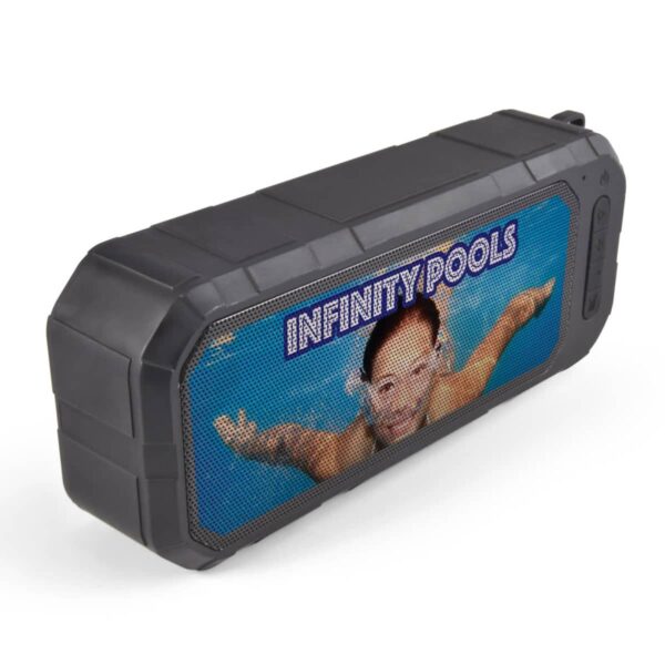 A black, rugged portable speaker with an image of a person swimming underwater on its front screen. The text INFINITY POOLS is displayed prominently above the swimmer.