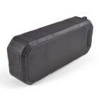A portable black Bluetooth speaker with a rugged, rectangular design. It features a textured front grille and protective casing, angled slightly to the right.