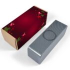 A rectangular gift box in festive red with ornaments and stars next to a shiny, textured silver box. The red box features Christmas decorations, while the silver box has a circular design on top. Both are placed on a white surface.