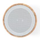 A circular speaker with a wooden frame and a perforated white grille viewed from above.