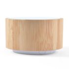 A round, wooden texture essential oil diffuser with a white top and a small white control panel at the base, isolated on a white background.