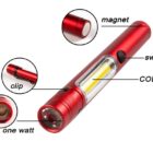 Red pen-shaped flashlight with labeled components: a magnet at the end, switch on the side, COB (Chip on Board) LED light, clip near the end, and a one-watt bulb at the front.