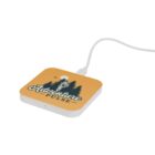 Orange wireless charger with Adventure Pulse design, featuring trees and a mountain climber.