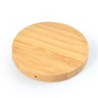 Round wooden cutting board on a white background.