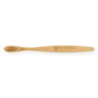 Bamboo toothbrush with engraved logo on handle, bristles facing sideways.