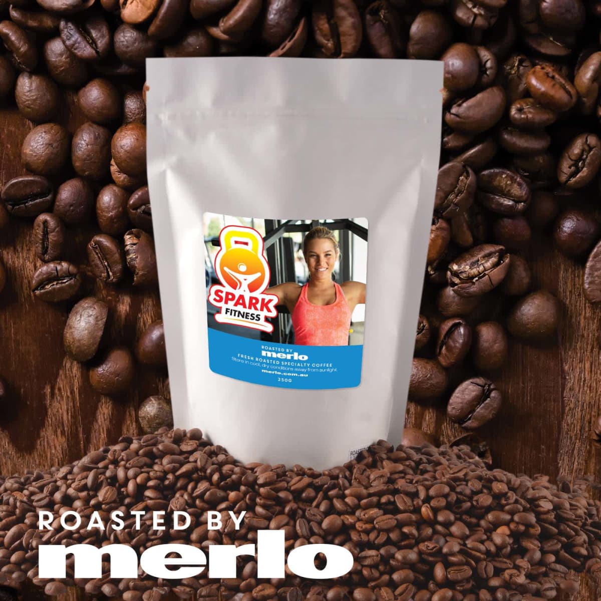Coffee bag with Spark Fitness label surrounded by coffee beans.