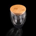 Glass jar with a wooden lid, placed on a reflective black surface.