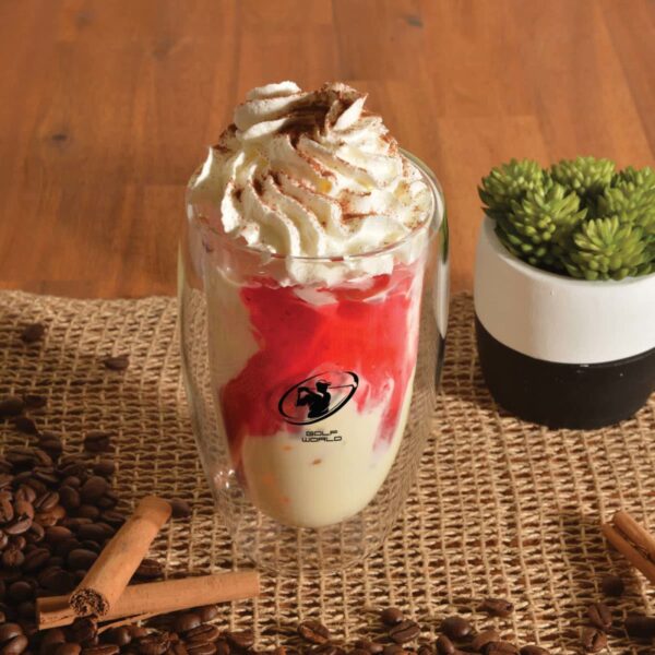Iced dessert in a transparent glass with whipped cream, on a burlap mat adorned with coffee beans.