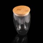 Clear glass container with a wooden lid on a black background.