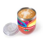 Coffee with latte art in a colorful Swallow Stationery cup; lid placed beside it.