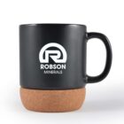 Black mug with Robson Minerals logo on cork coaster base.