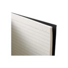 Edge view of an open, lined notebook with a black cover.